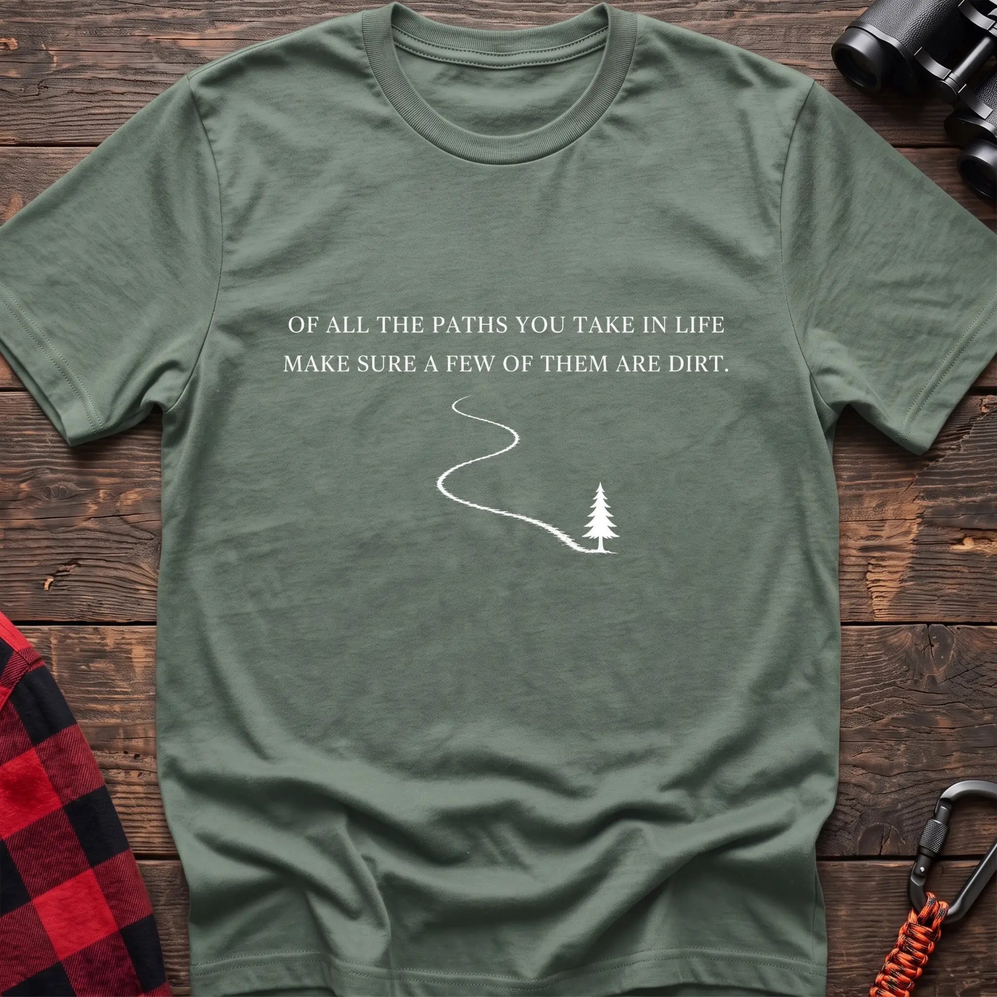 Sage cotton hiking t-shirt with white quote "Of all the paths you take in life make sure a few of them are dirt" and winding dirt path to pine tree graphic