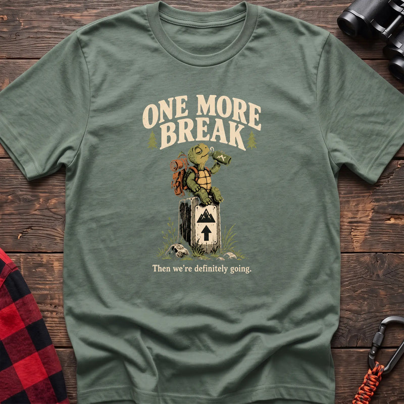 Sage cotton t-shirt with a hiking turtle graphic and One More Break text on rustic wood