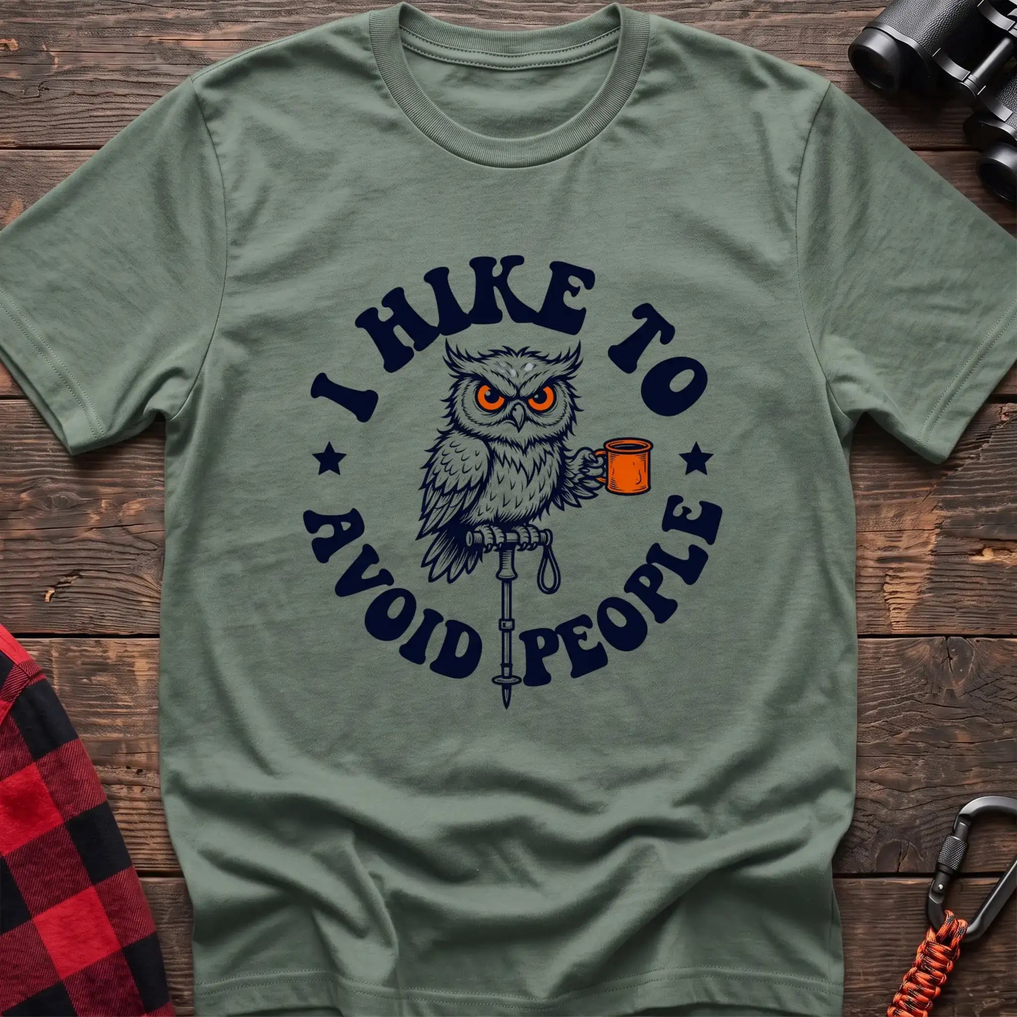 Sage t-shirt with owl holding a camping mug on a hiking pole and the text I Hike to Avoid People