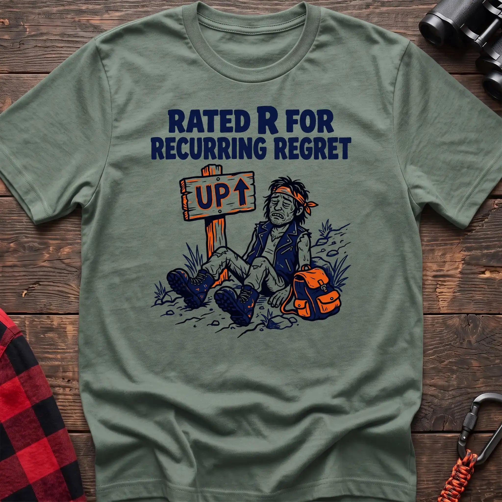 Sage t-shirt with illustration of an exhausted hiker sitting by an UP trail sign and the text Rated R for Recurring Regret
