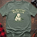 Sage cotton t-shirt with a sitting backpack bear graphic and The Reluctant Hikers Club text on rustic wood