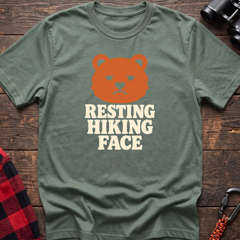 Sage cotton t-shirt with a grumpy bear graphic and Resting Hiking Face text on rustic wood