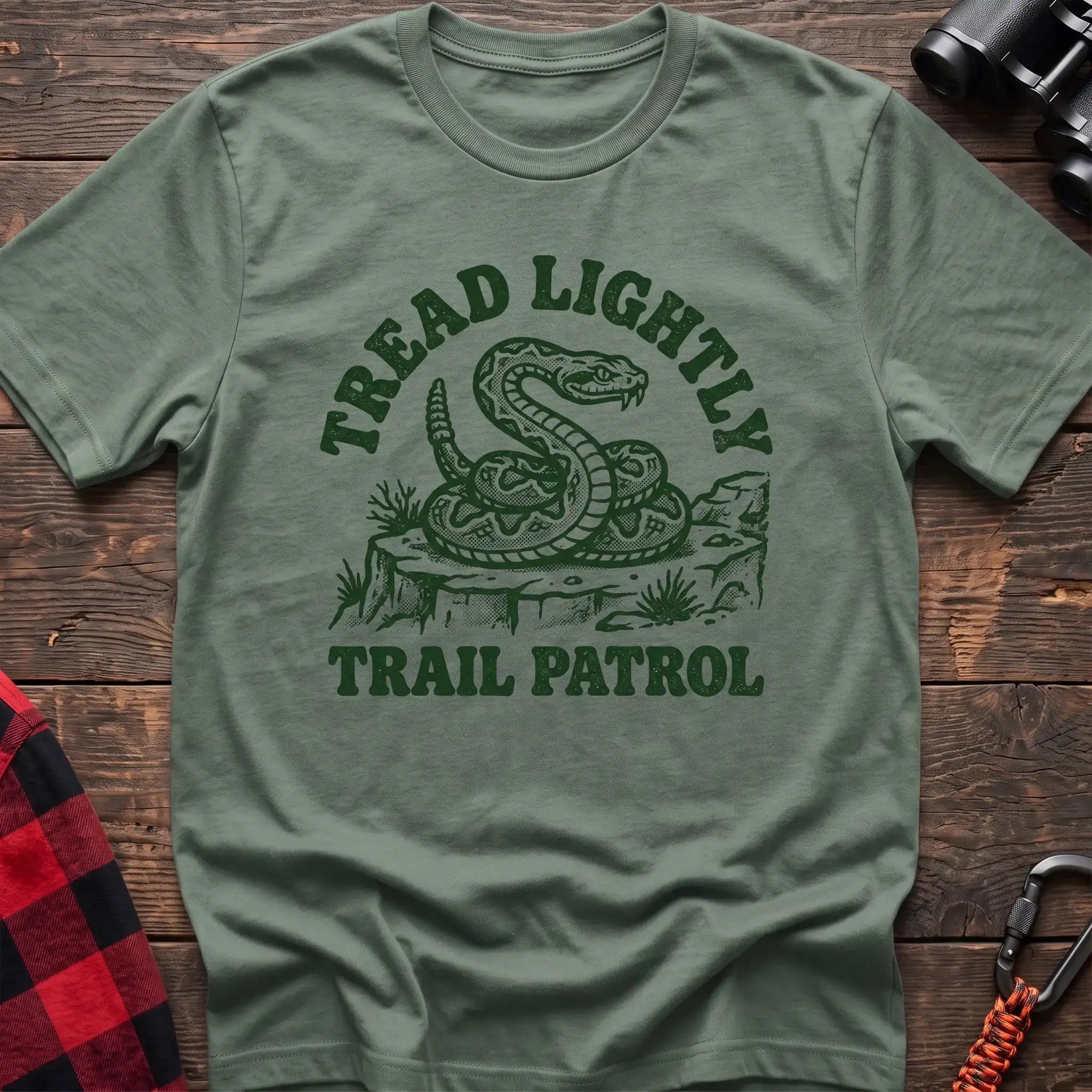 Sage t-shirt with dark green rattlesnake illustration and the text Tread Lightly Trail Patrol