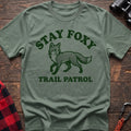 Sage green t-shirt with dark green fox illustration and the text Stay Foxy Trail Patrol