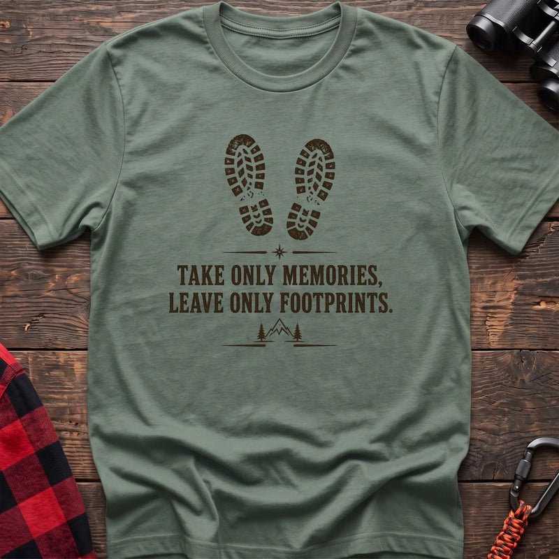 Sage hiking graphic T-shirt with boot prints and “Take only memories, leave only footprints” trail design