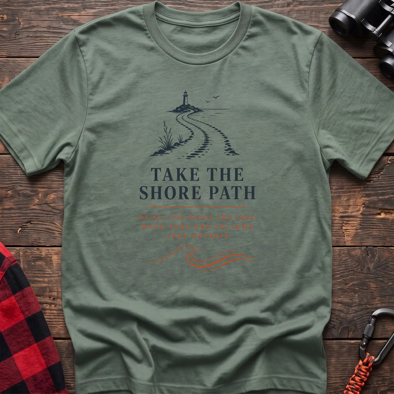 Sage cotton hiking t-shirt with lighthouse and winding shore path graphic and "Take the Shore Path – make sure one follows Lake Ontario" quote