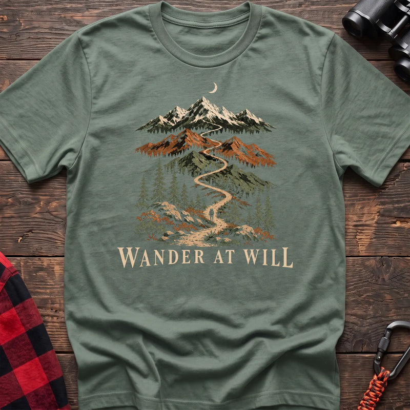 Sage cotton t-shirt with a mountain trail graphic and Wander at Will text on rustic wood