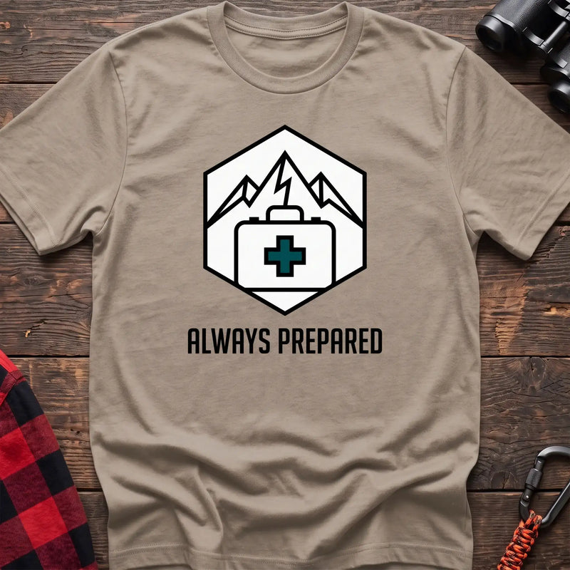 Sand t-shirt with hexagonal badge graphic of mountains and a first aid kit, reading Always Prepared