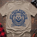 Sand t-shirt with circular badge of a serious bear face reading Anti-Social Hiking Club Solo Division