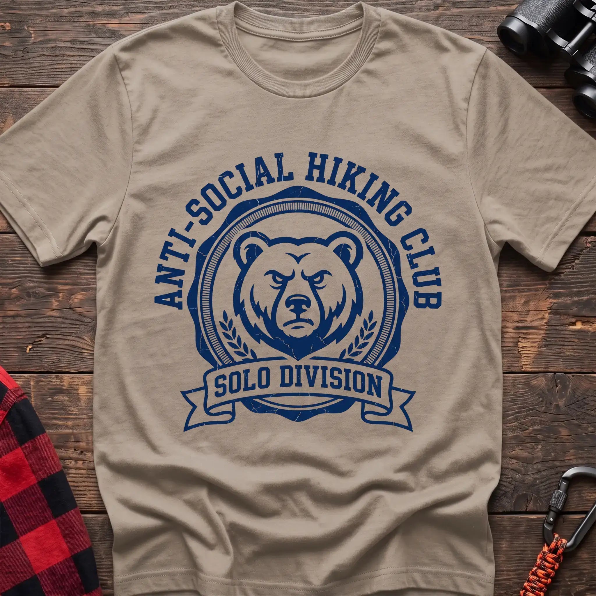 Sand t-shirt with circular badge of a serious bear face reading Anti-Social Hiking Club Solo Division