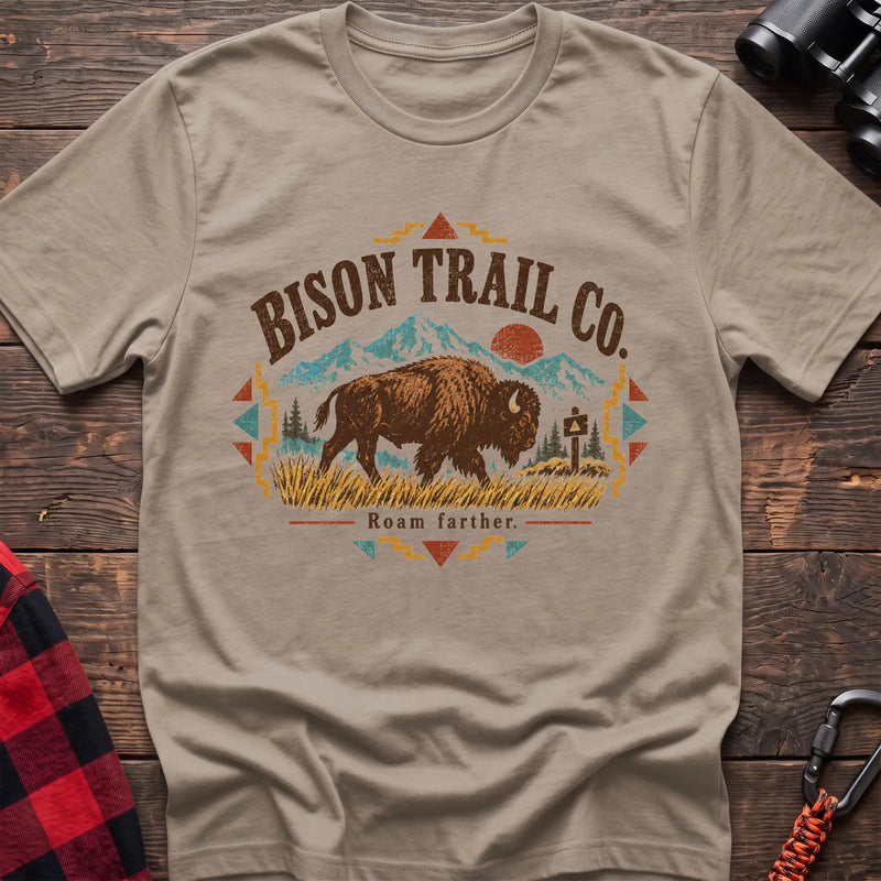Sand cotton t-shirt with a bison and mountain graphic and Bison Trail Co text on rustic wood