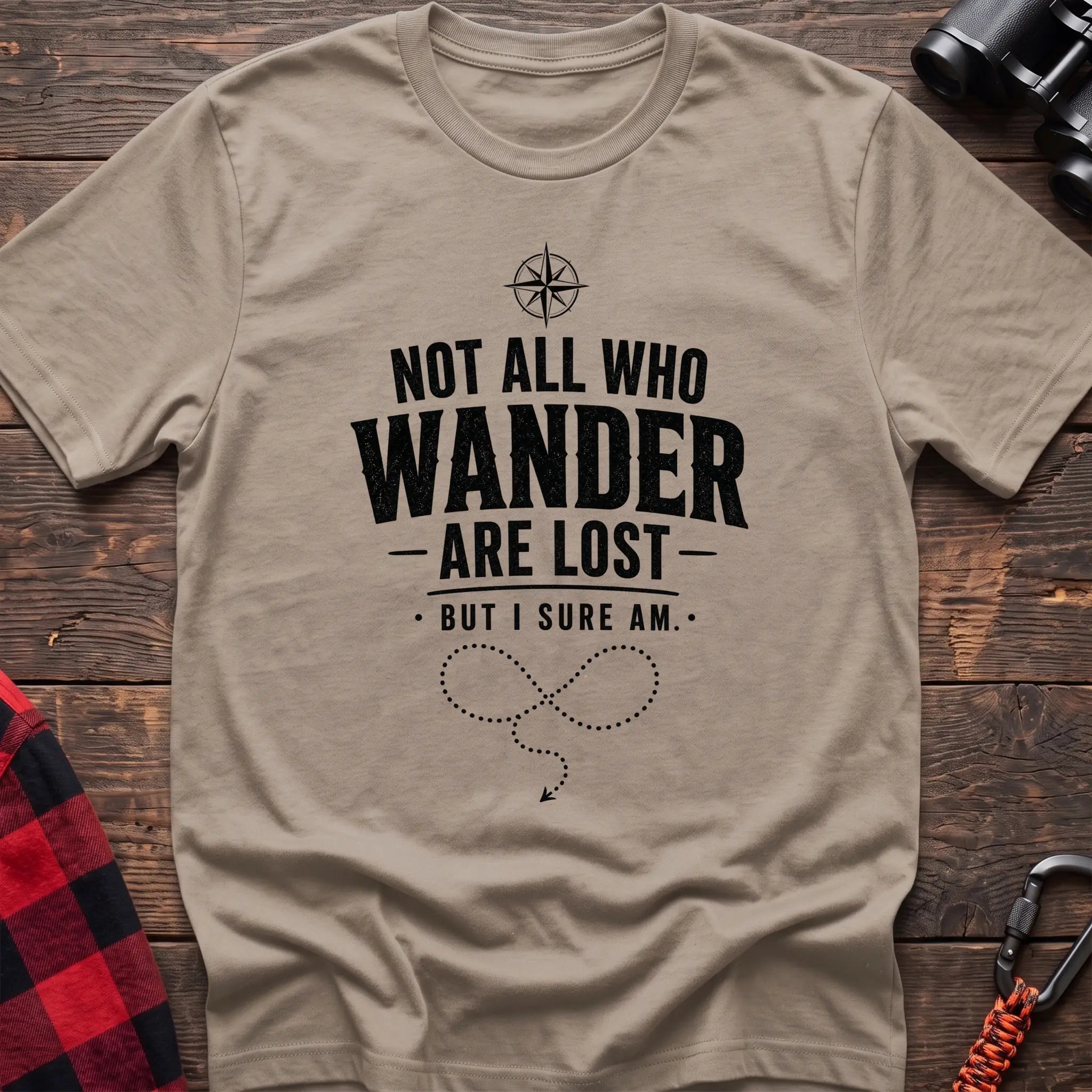 Sand cotton hiking t-shirt with compass, "Not all who wander are lost but I sure am" quote, and dotted wandering path graphic