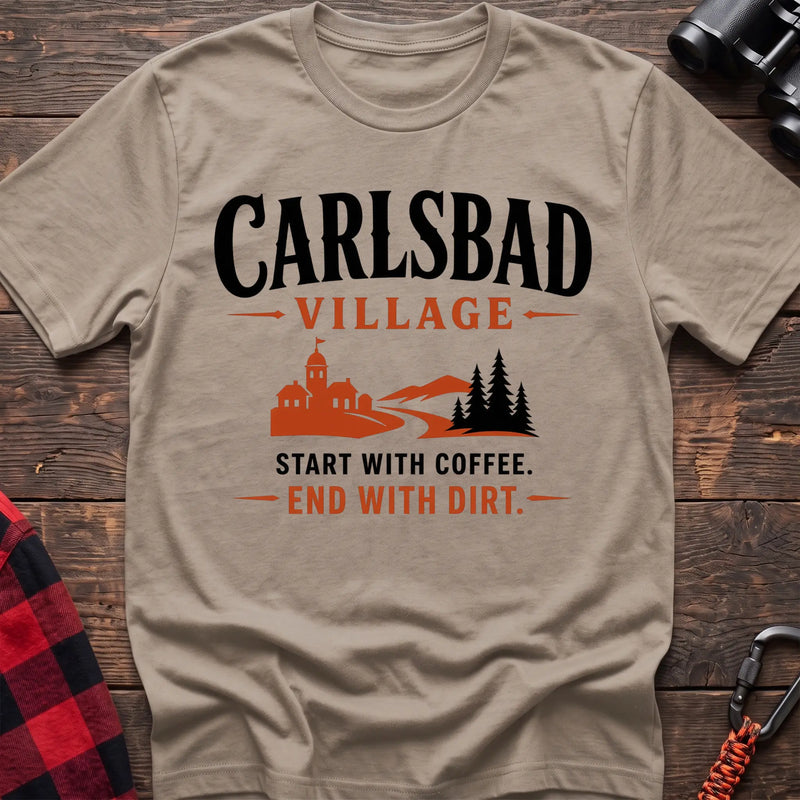 Sand cotton t-shirt with a village and trail graphic and Carlsbad Village Start with Coffee End with Dirt text on rustic wood