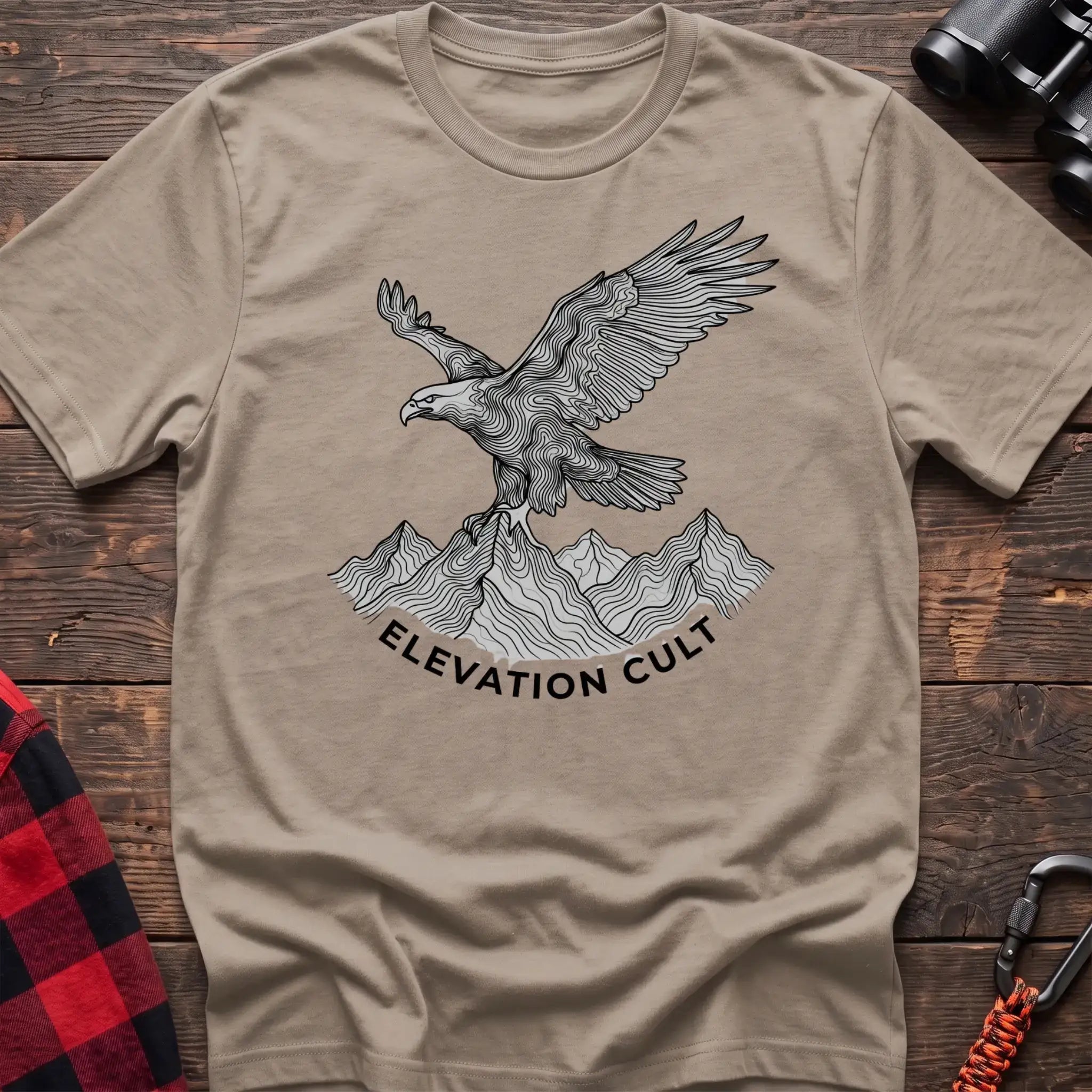 Sand t-shirt with detailed eagle perched on mountains graphic and the text Elevation Cult