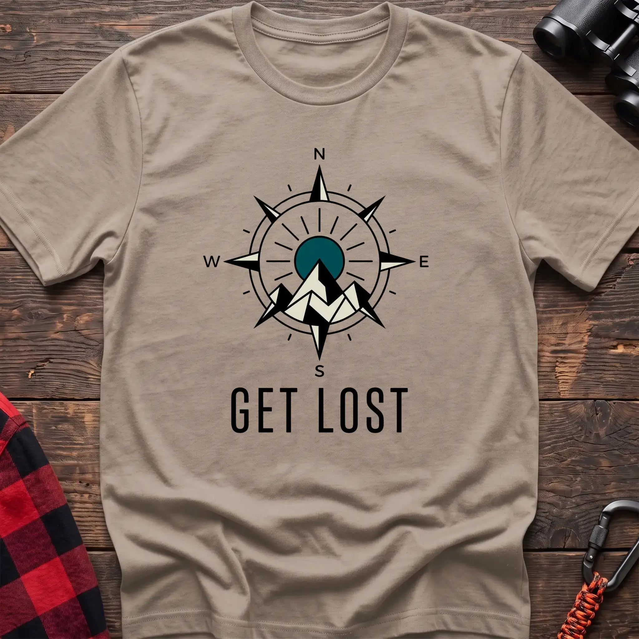 Sand t-shirt with compass rose graphic featuring mountains in the center and the text Get Lost
