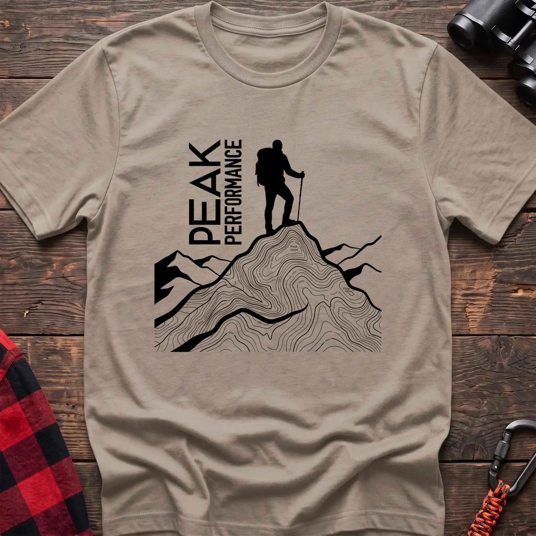 Sand t-shirt with hiker silhouette on a topographic mountain peak and the text Peak Performance
