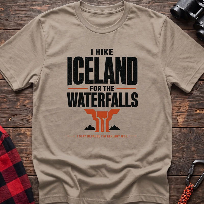 Sand cotton t-shirt with a waterfall graphic and I Hike Iceland for the Waterfalls text on rustic wood