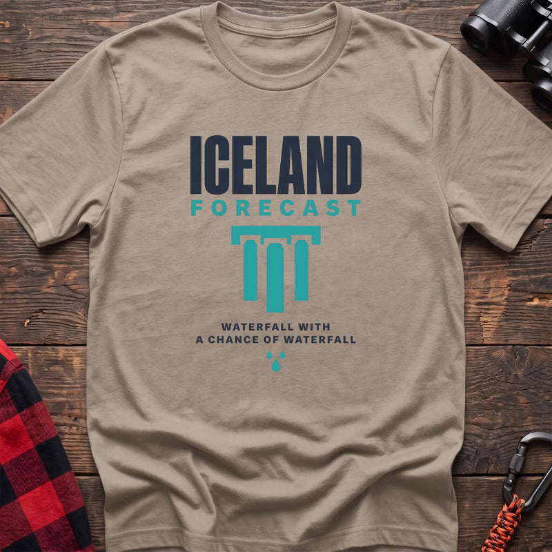 Sand cotton t-shirt with an Iceland Forecast graphic and Waterfall with a Chance of Waterfall text on rustic wood
