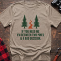 Sand cotton t-shirt with two pines and a trail graphic and If You Need Me I’m Between Two Pines and a Bad Decision text on rustic wood