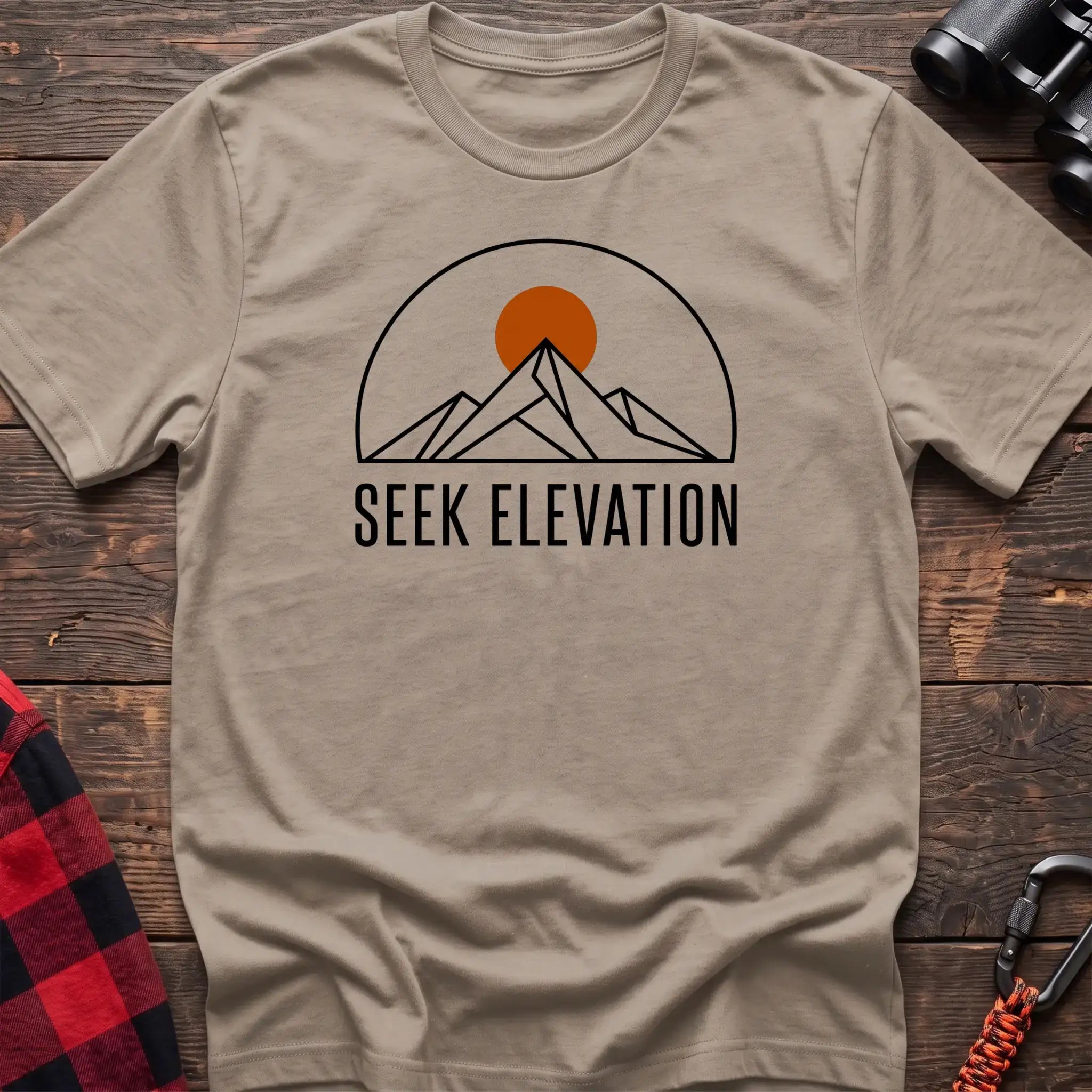 Sand t-shirt with minimalist mountain and sun graphic reading Seek Elevation