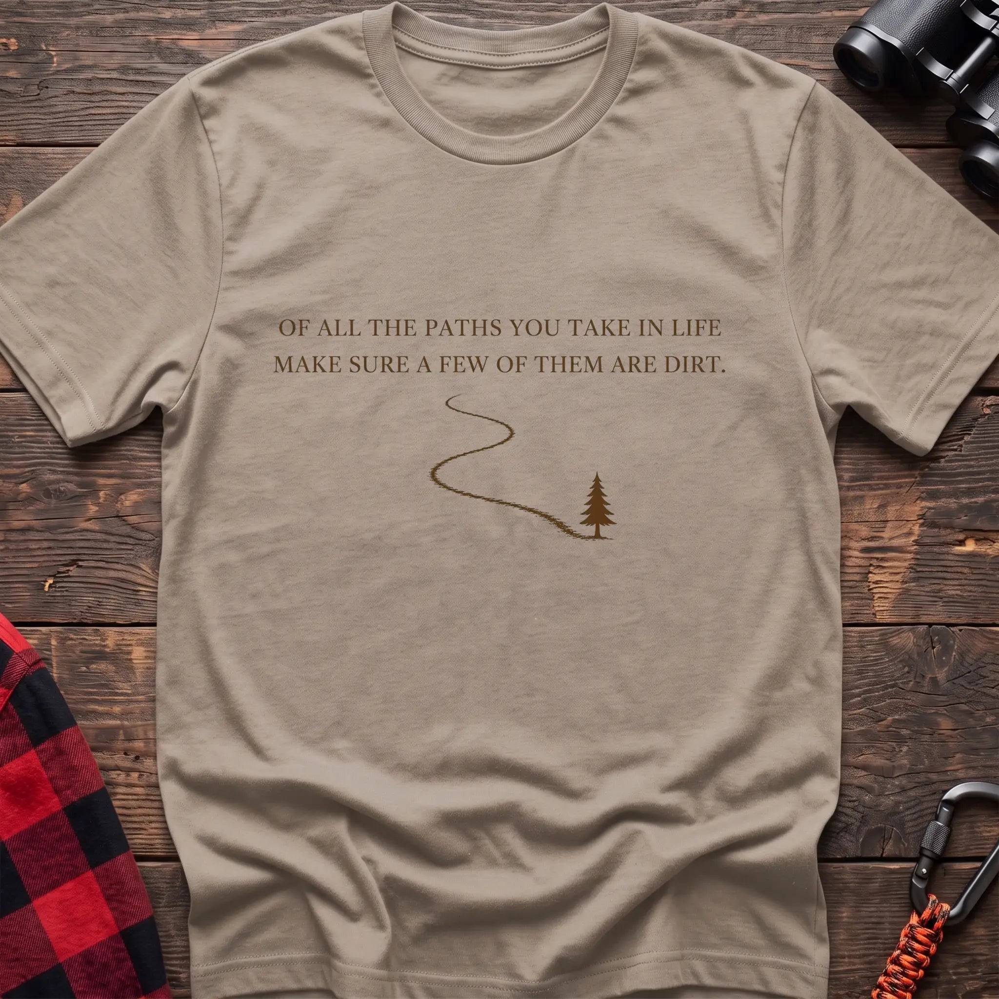 Sand cotton hiking t-shirt with white quote "Of all the paths you take in life make sure a few of them are dirt" and winding dirt path to pine tree graphic