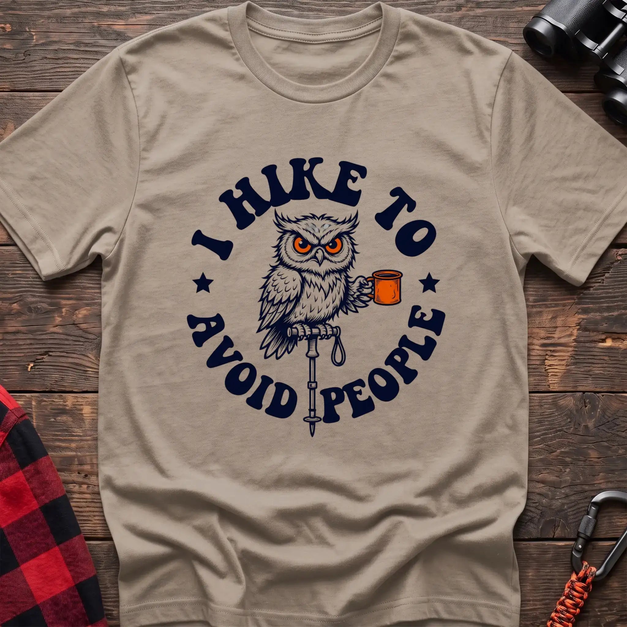 Sand t-shirt with owl holding a camping mug on a hiking pole and the text I Hike to Avoid People