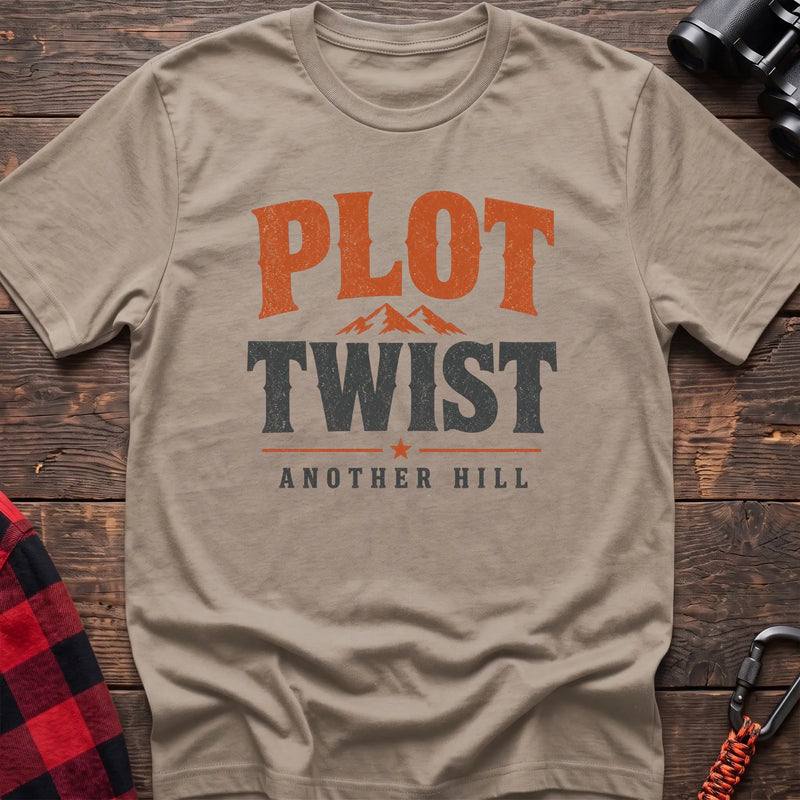 Sand cotton t-shirt with a mountain graphic and Plot Twist Another Hill text on rustic wood