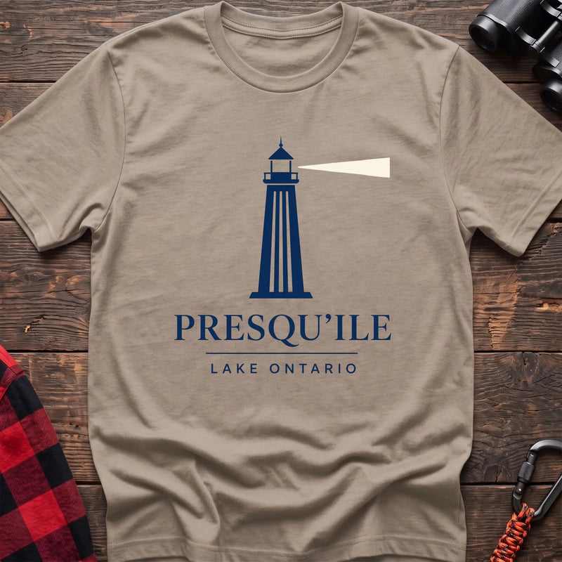 Sand cotton t-shirt with a navy lighthouse graphic and the text “Presqu’ile Lake Ontario”