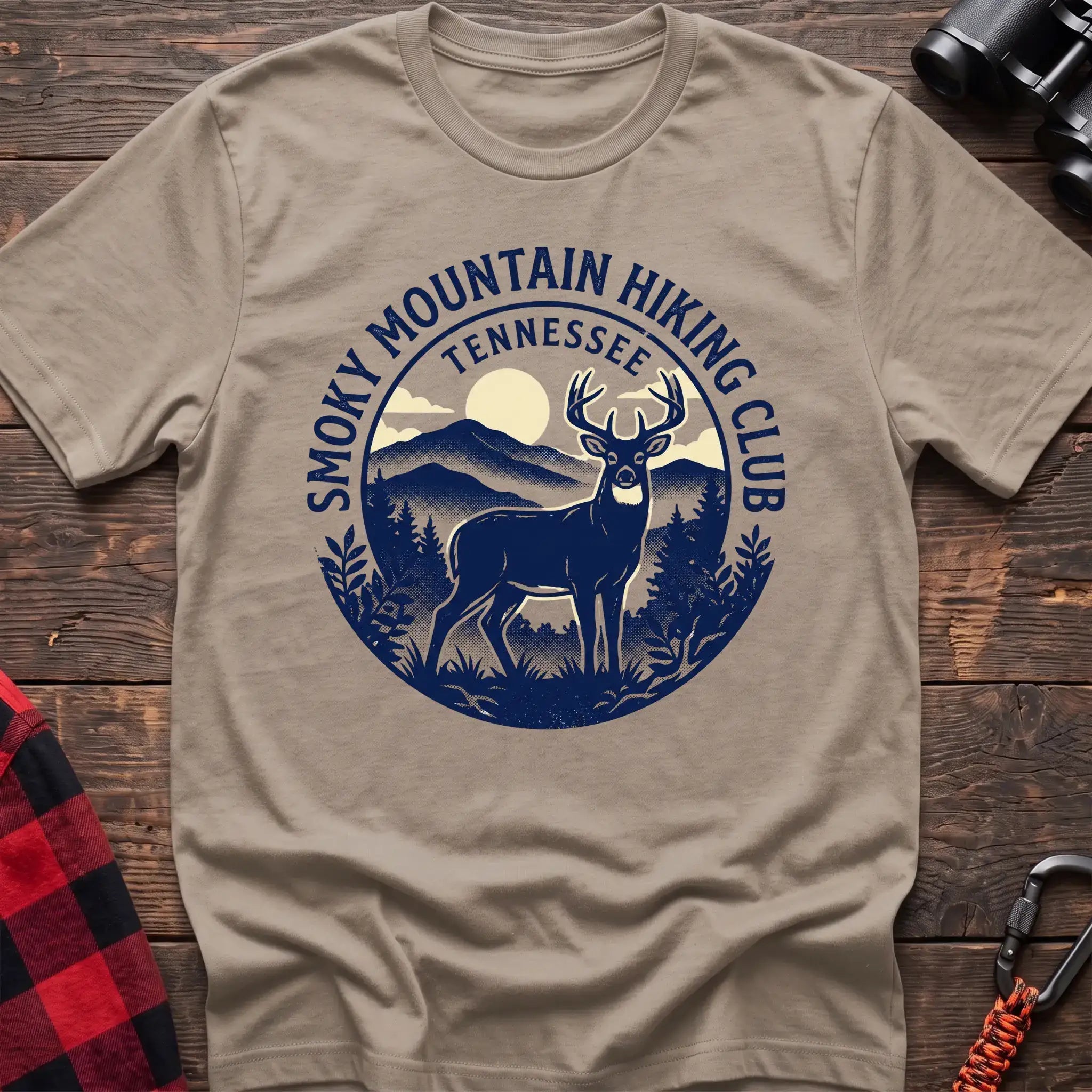 Sand t-shirt with circular badge graphic of a deer in the mountains reading Smoky Mountain Hiking Club Tennessee
