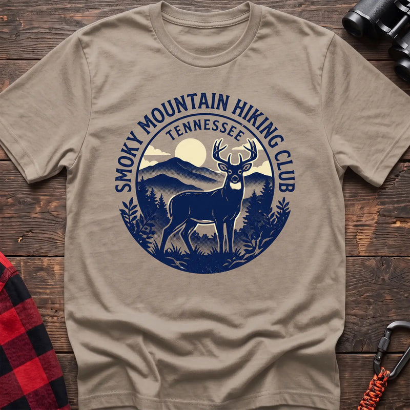 Sand t-shirt with circular badge graphic of a deer in the mountains reading Smoky Mountain Hiking Club Tennessee
