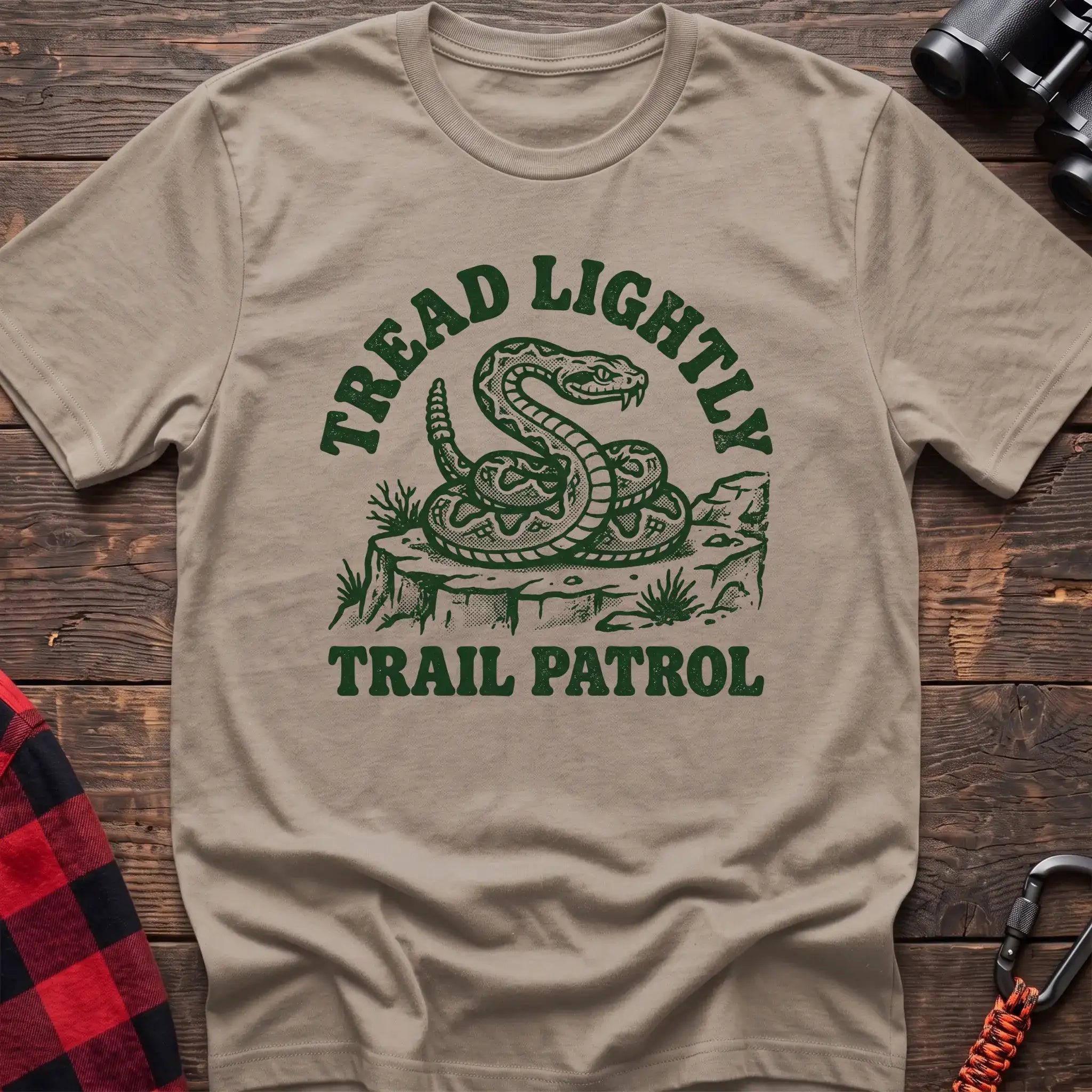 Sand t-shirt with dark green rattlesnake illustration and the text Tread Lightly Trail Patrol