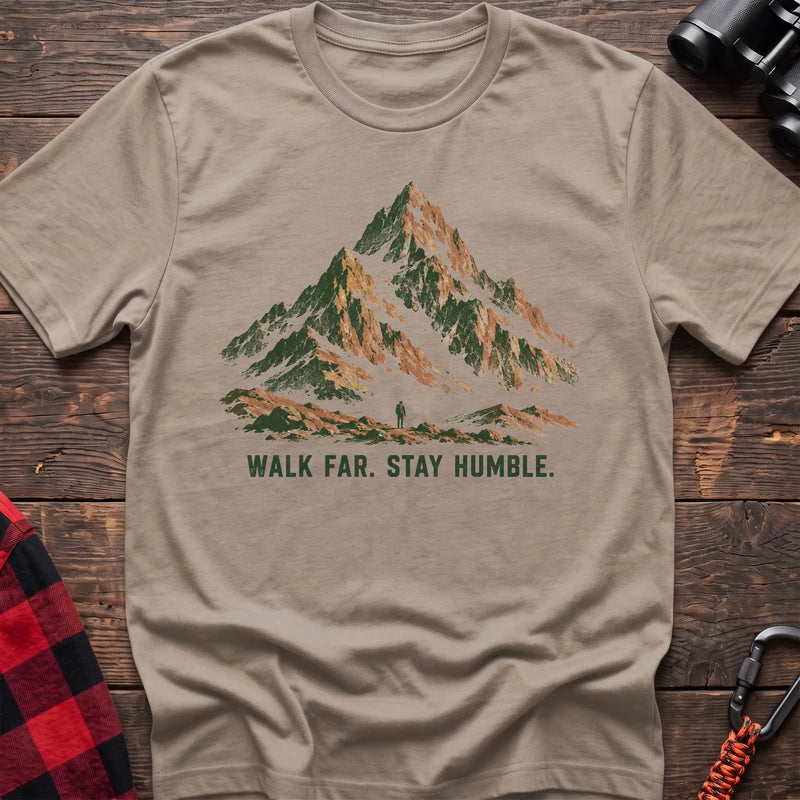 Sand cotton t-shirt with a mountain and hiker graphic and Walk Far Stay Humble text on rustic wood