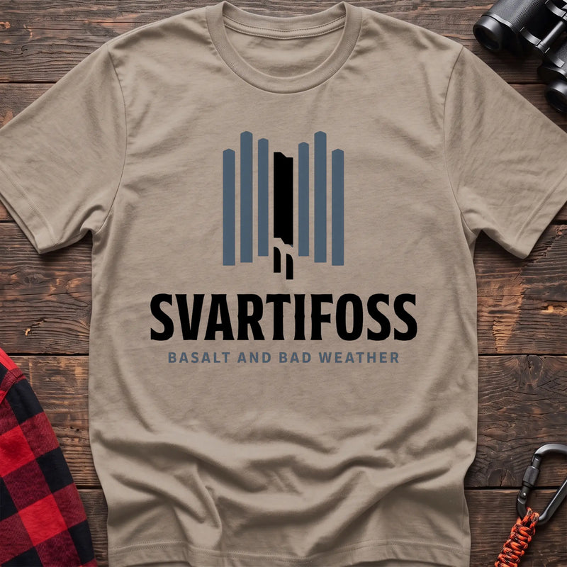 Sand cotton t-shirt with a basalt column graphic and Svartifoss Basalt and Bad Weather text on rustic wood