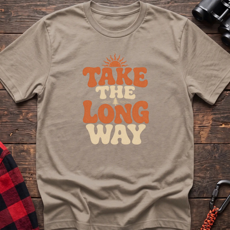 Sand cotton t-shirt with retro wavy text and Take the Long Way lettering on rustic wood