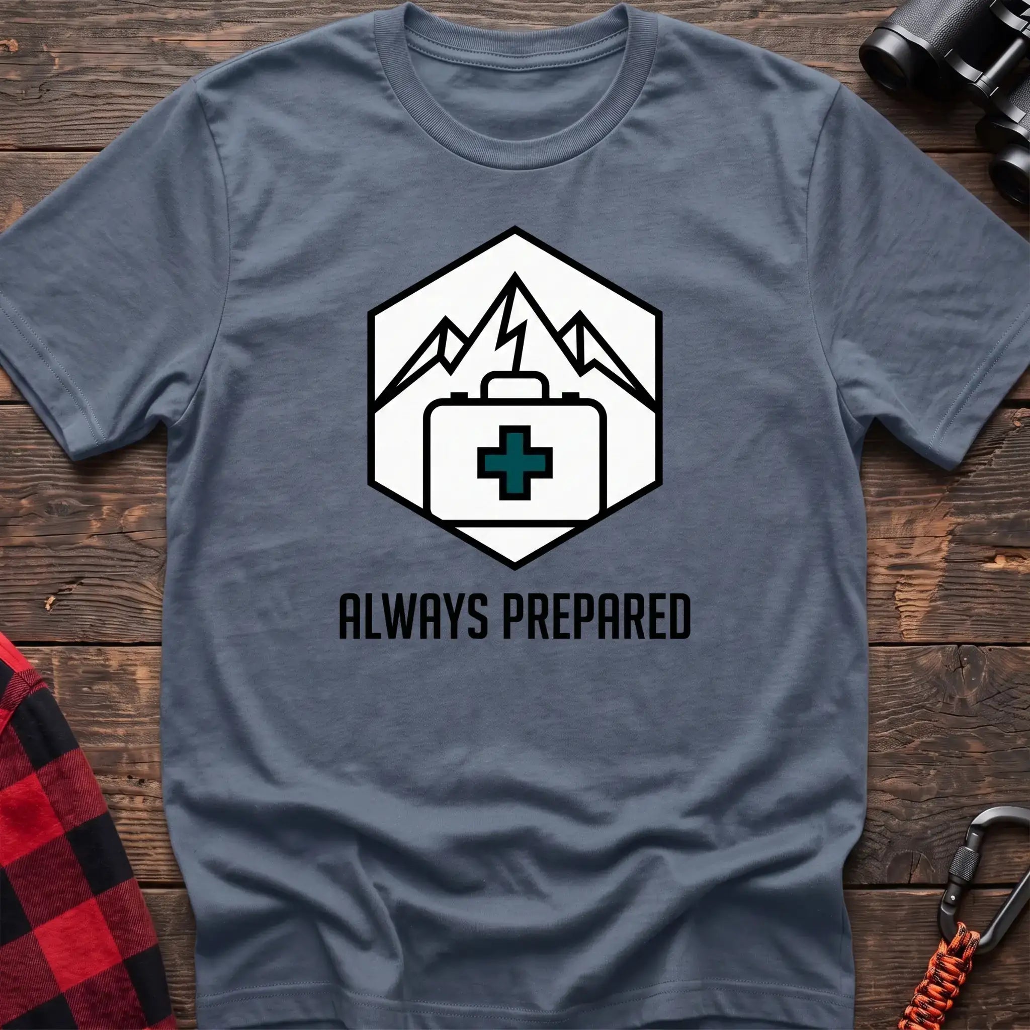 Stone blue t-shirt with hexagonal badge graphic of mountains and a first aid kit, reading Always Prepared
