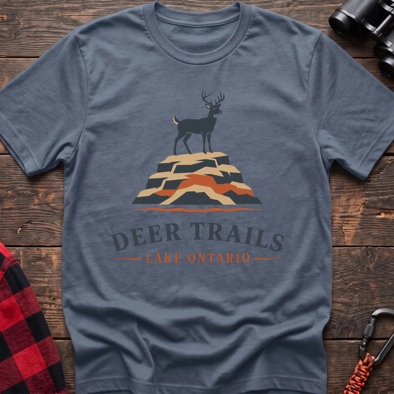 Stone blue hiking t-shirt with a deer on a rocky bluff and the text “Deer Trails Lake Ontario”