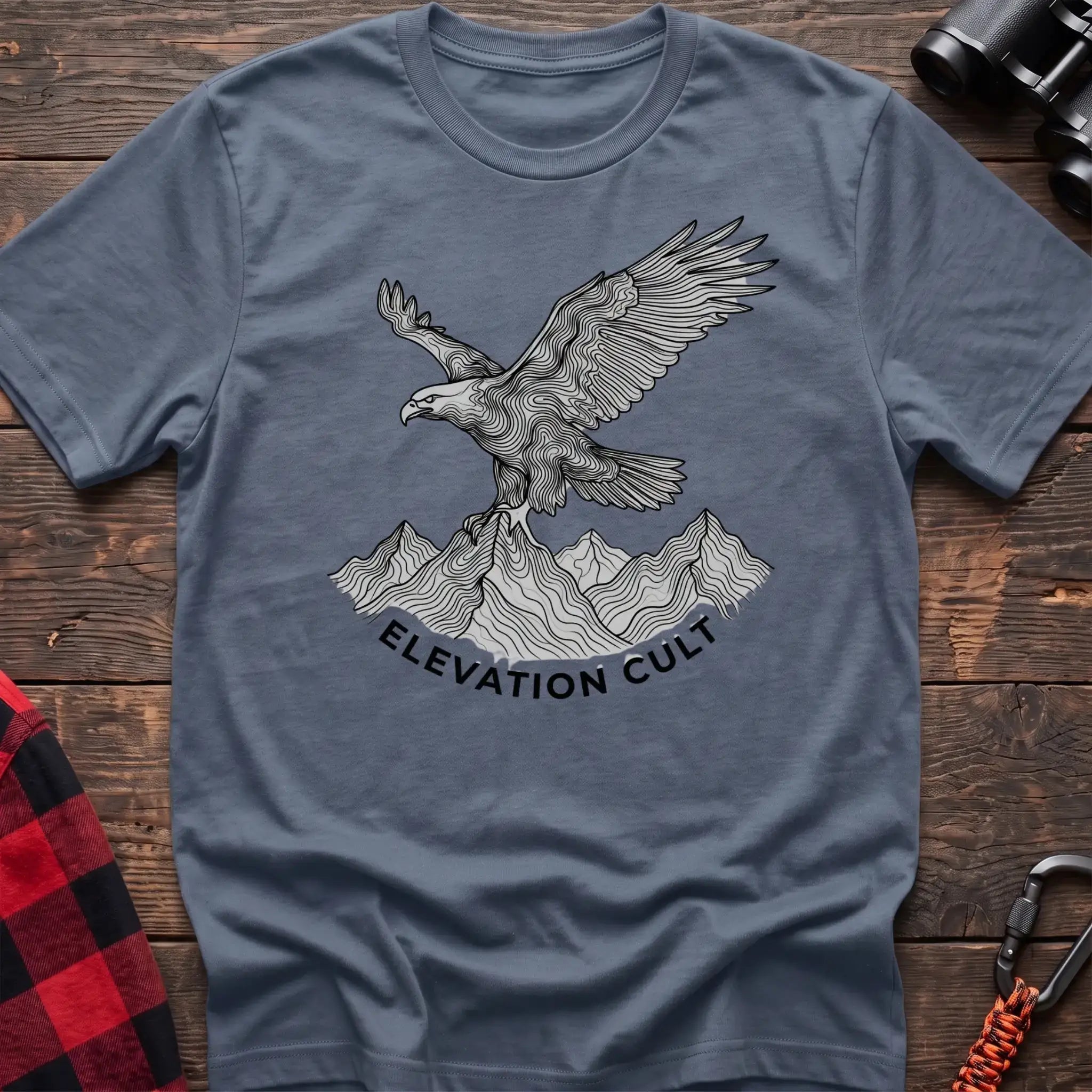 Stone blue t-shirt with detailed eagle perched on mountains graphic and the text Elevation Cult