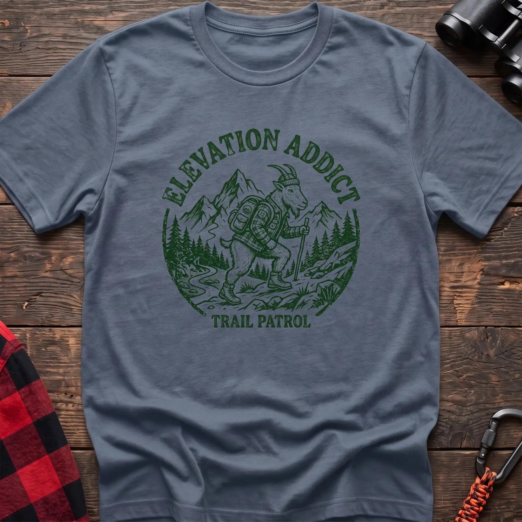 Stone blue t-shirt with circular graphic of a hiking mountain goat and the text Elevation Addict Trail Patrol