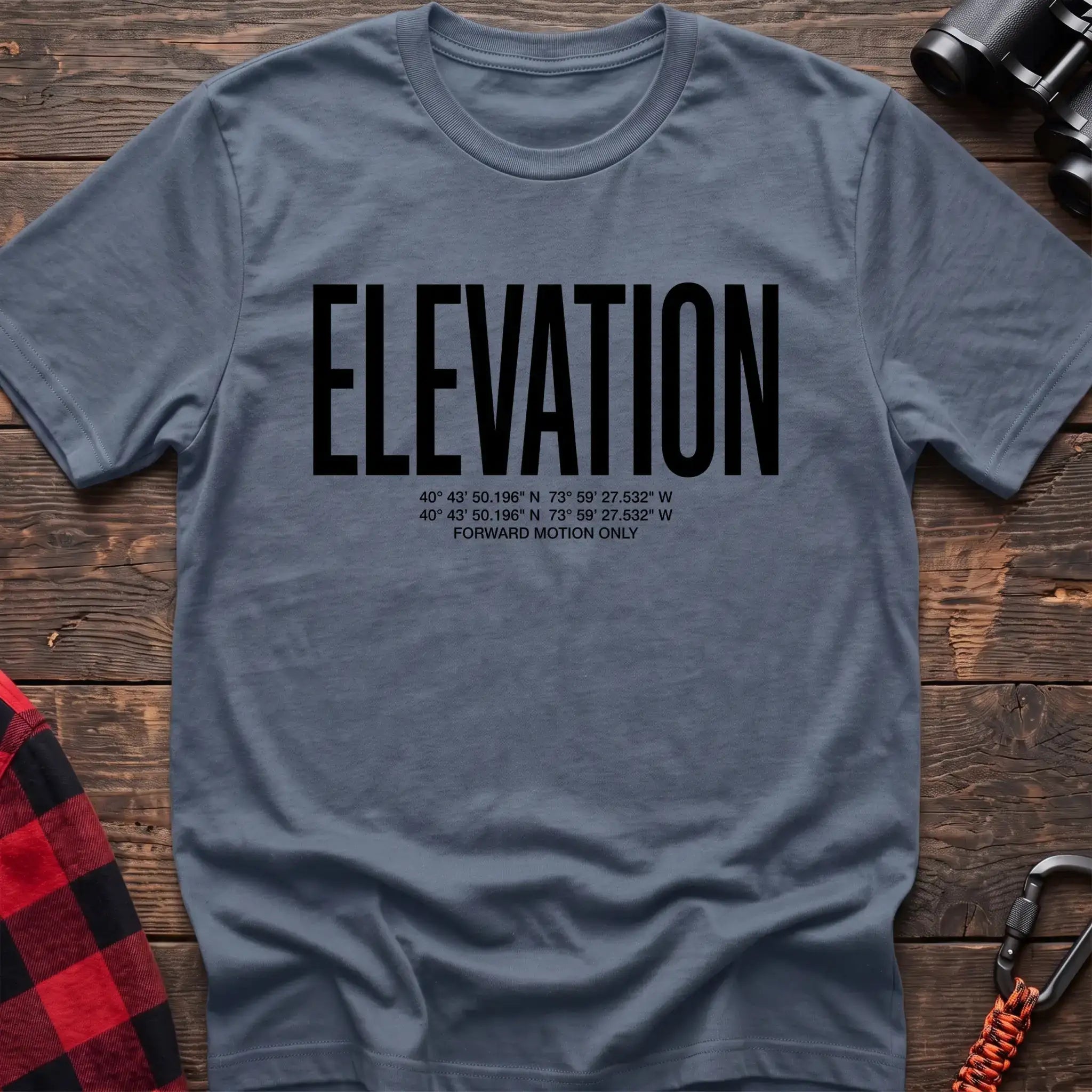 Stone blue t-shirt with large black text reading Elevation and GPS coordinates with Forward Motion Only