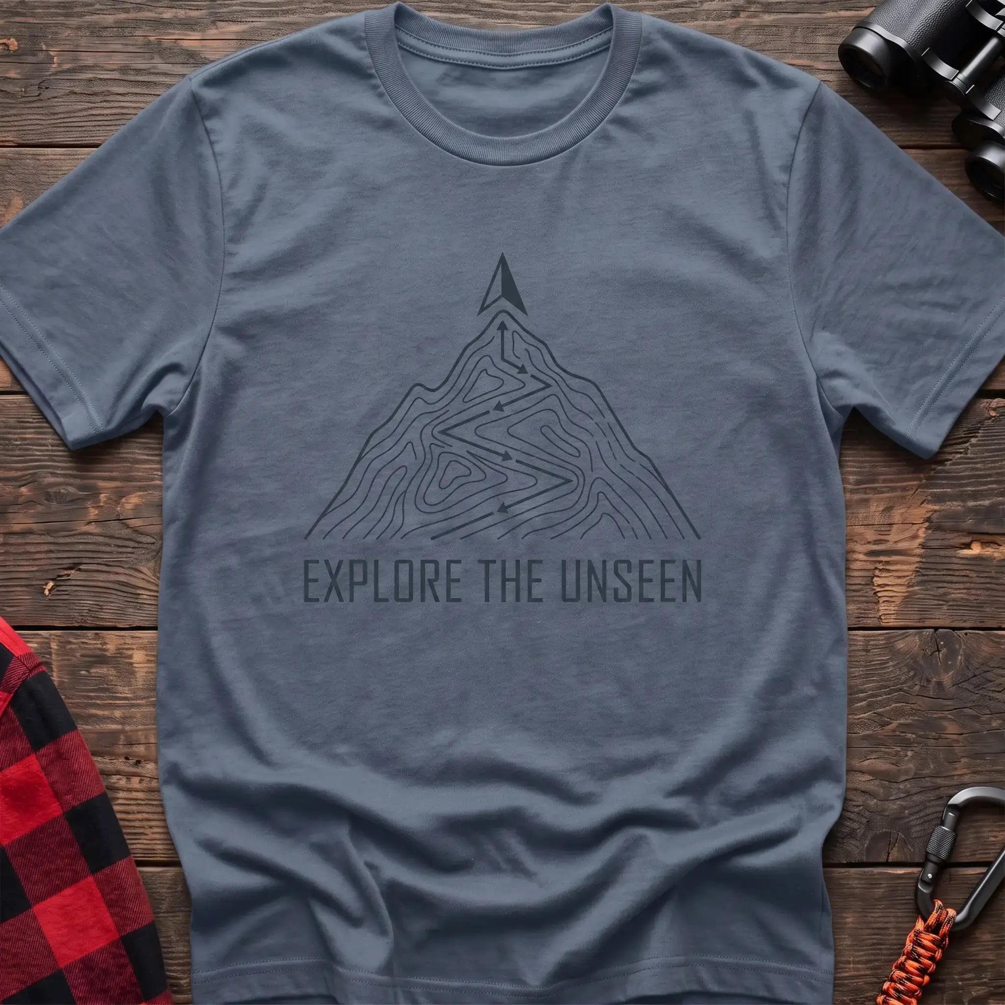 Stone blue t-shirt with topographic mountain trail graphic and the text Explore the Unseen