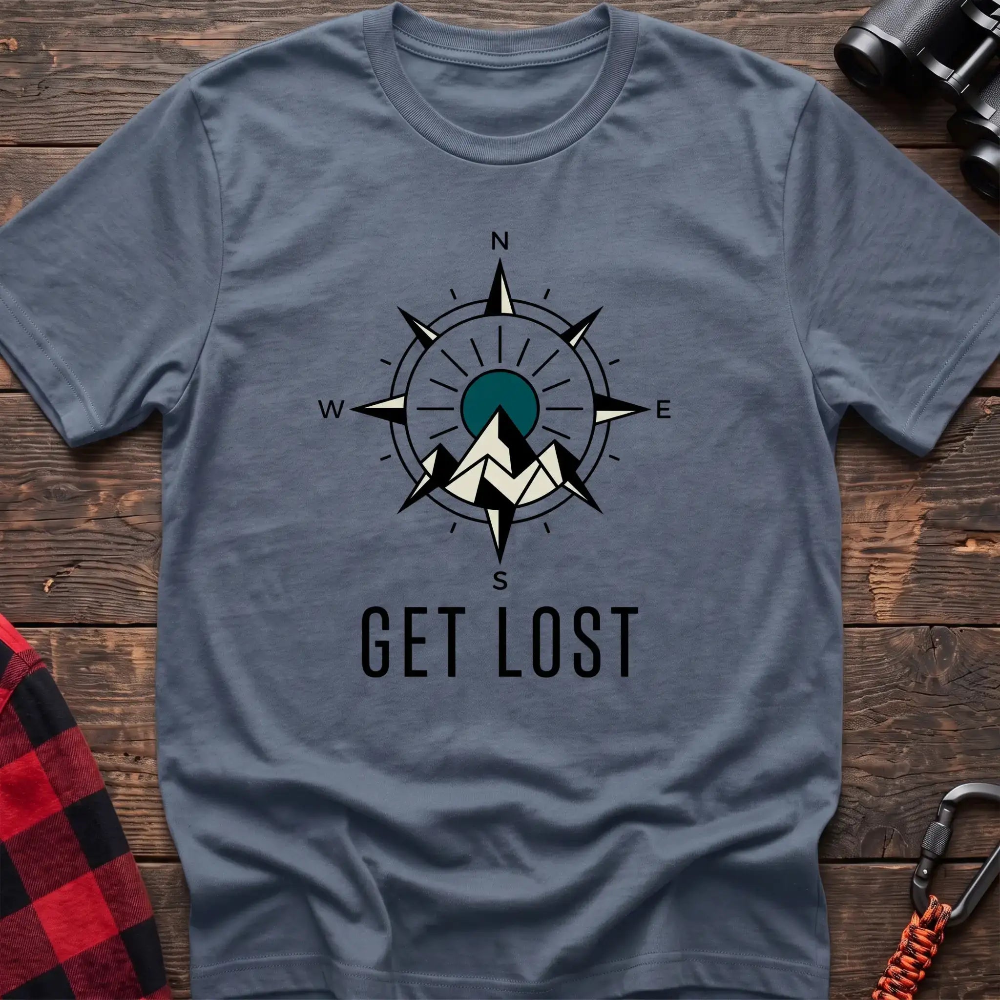 Stone blue t-shirt with compass rose graphic featuring mountains in the center and the text Get Lost
