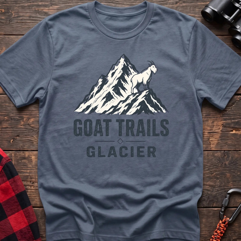 Stone blue cotton t-shirt with a mountain goat on a peak graphic and Goat Trails Glacier text on rustic wood