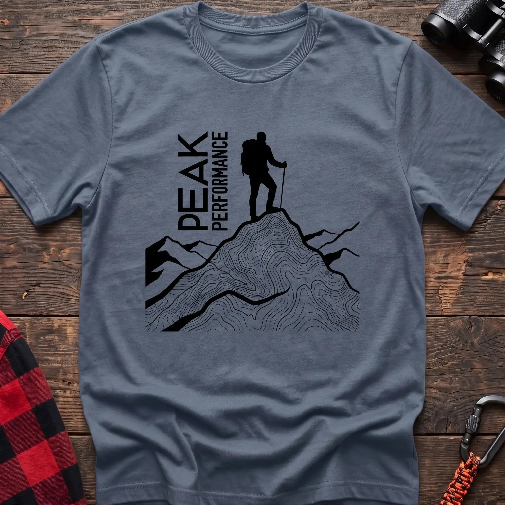 Stone blue t-shirt with hiker silhouette on a topographic mountain peak and the text Peak Performance