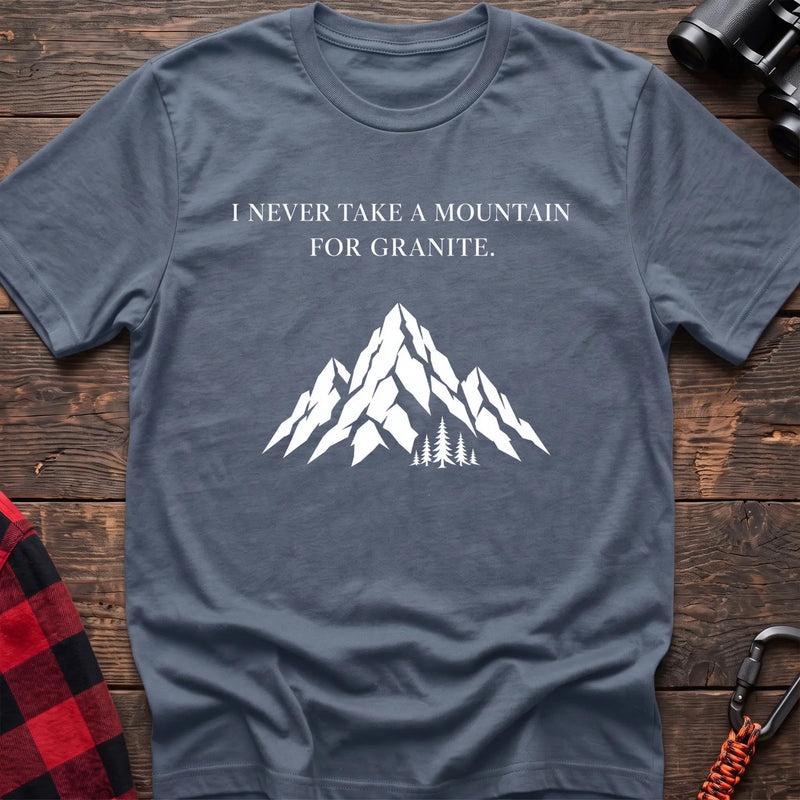 Stone blue cotton t-shirt with a mountain graphic and I Never Take a Mountain for Granite text on rustic wood