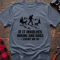 Stone blue cotton hiking t-shirt with hiker and two dogs silhouette on a mountain trail and "If it involves hiking and dogs count me in" quote