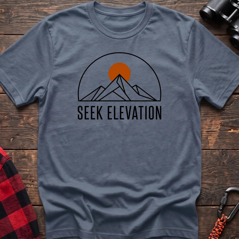 Stone blue t-shirt with minimalist mountain and sun graphic reading Seek Elevation