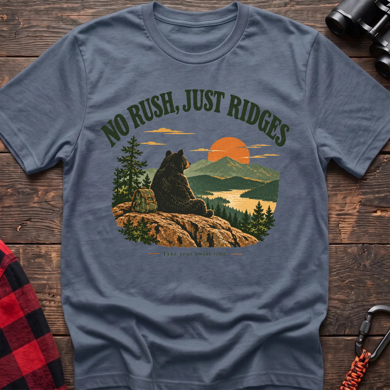 Stone blue cotton t-shirt with a bear on a ridge graphic and No Rush Just Ridges text on rustic wood