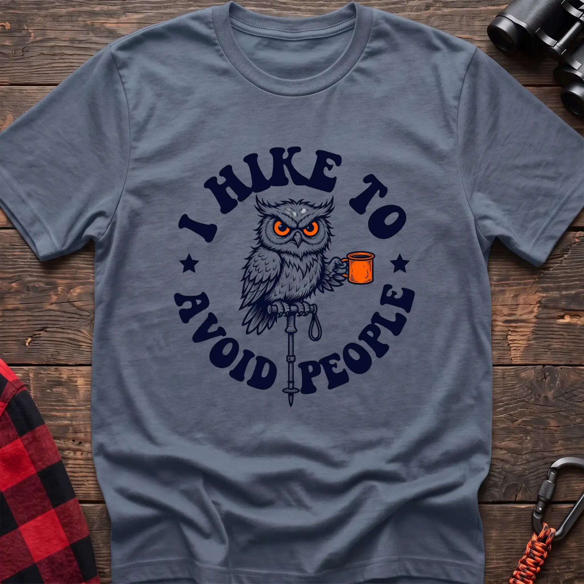 Stone blue t-shirt with owl holding a camping mug on a hiking pole and the text I Hike to Avoid People