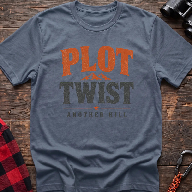 Stone blue cotton t-shirt with a mountain graphic and Plot Twist Another Hill text on rustic wood