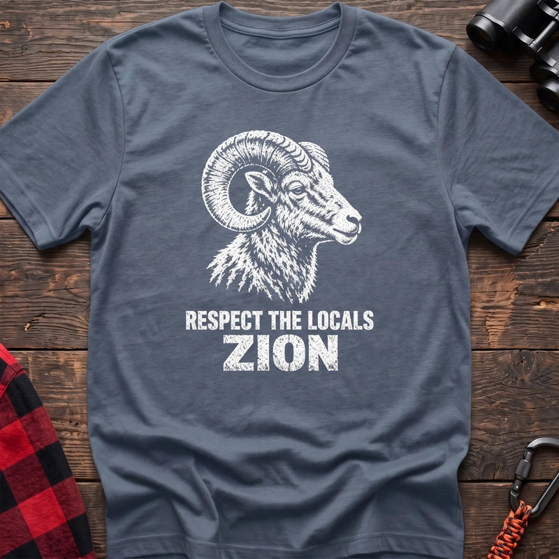 Stone blue cotton t-shirt with a bighorn ram graphic and Respect the Locals Zion text on rustic wood